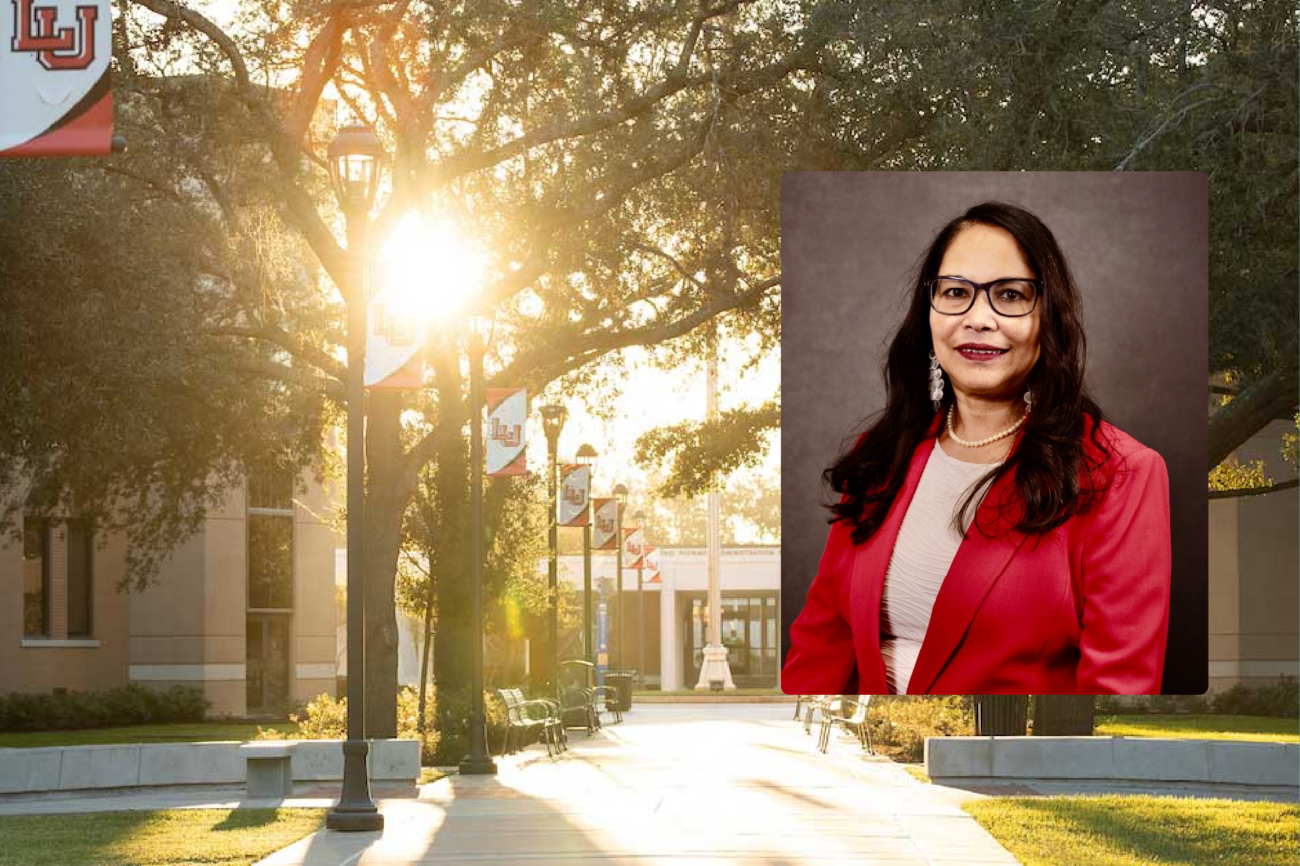 Portrait of Dr. Kakoli Bandyopadhyay in a red blazer, over a sunlit Lamar University campus walkway.