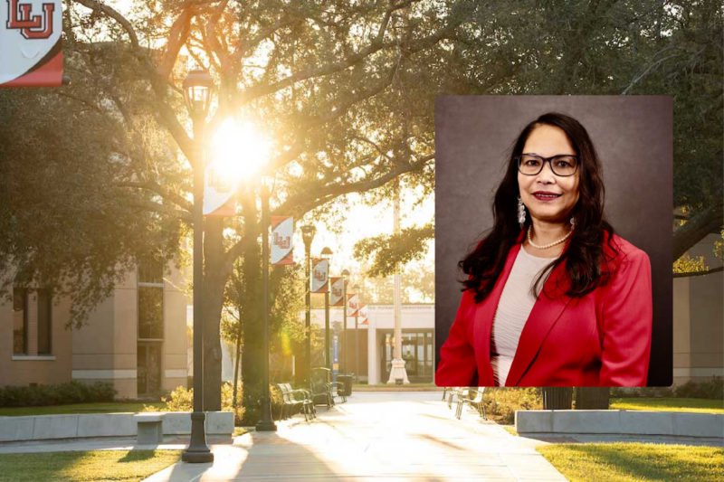 Portrait of Dr. Kakoli Bandyopadhyay in a red blazer, over a sunlit Lamar University campus walkway.